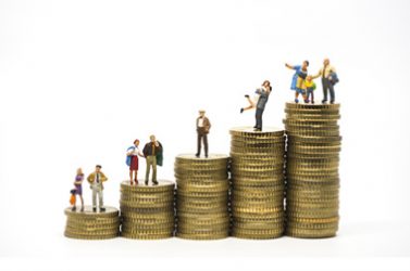 Faily budget concept. Miniature family on coins pile.