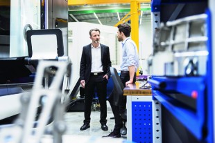 Two men talking in factory shop floor
