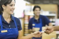 Handing Loyalty Card In Supermarket
