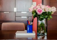 Working table with vase of roses in modern room