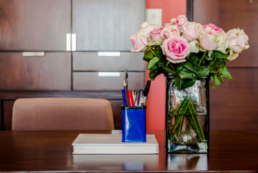 Working table with vase of roses in modern room