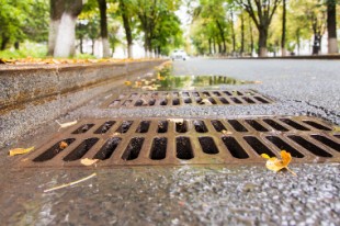 Rain water flows down the hatch cover on a sunny autumn day