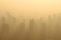 Buildings under construction with cranes in misty morning, Bangkok, Thailand