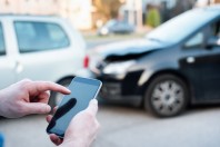 Man calling roadside emergency after car accident