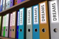 Office binders with DREAMS inscription. 3D rendering