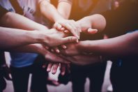 Arms together, teamwork. Collaboration