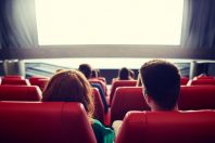 happy couple watching movie in theater or cinema