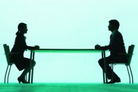Businessman and businesswoman at a table