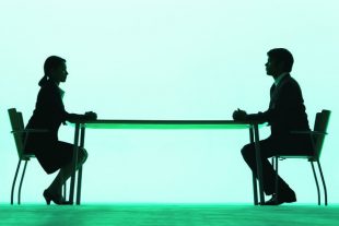 Businessman and businesswoman at a table