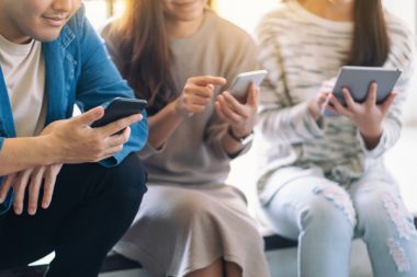 Group of people using and looking at mobile phone and tablet pc