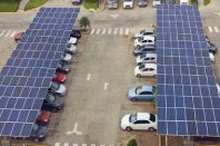 Parking lot with solar panel on roof aerial above view
