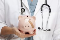 Female Doctor with Stethoscope Holding Piggy Bank with Bandage on Face.
