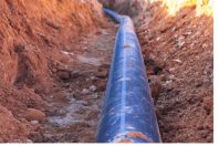 A black plastic pipe with a blue strip to feed water to the hous