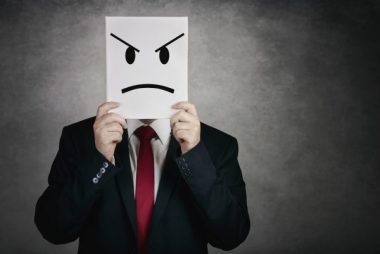 angry man with white board on gray background