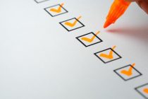 Orange marking on checklist box with pen, Checklist concept