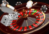 Casino background. Luxury Casino roulette wheel on black background. Casino theme. Close-up white casino roulette with a ball, chips and dice. Poker game table. 3d rendering illustration.