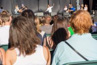 Rear view of audience at open air theatre in city center.