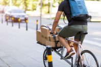 Bicycle messenger making a delivery on a cargo bike