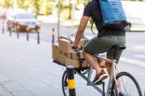 Bicycle messenger making a delivery on a cargo bike