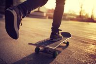 Skateboarder skateboarding at sunrise city