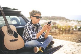 smartphone-jeune-guitare-Fabio Principe-AdobeStock_311068578