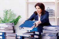 Middle-aged businesswoman unhappy with excessive work