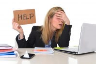 young beautiful business woman suffering stress working at office computer desk asking for help feeling tired and desperate looking overworked covering eyes overwhelmed and frustrated