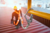 Construction worker wearing safety harness and safety line