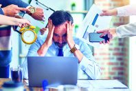 Group of business workers working together. Partners stressing one of them at the office