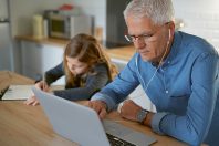 Father and school-girl working form home, telework and e-learnin