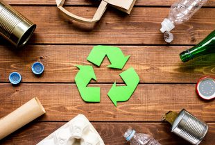Eco concept with recycling symbol on table background top view