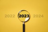 2023 year inside of magnifier glass among 2022 and 2023 for focu