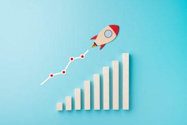 Rocket and chart on blue background business financial start up