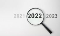 2022 inside of Magnifier glass on white background for focus current situation, positive thinking mindset concept. 2022 in focus. 2021 2022 2023 on white background, top view