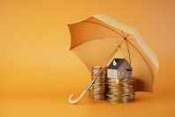 Insurance when buying a home. coins and a house under an umbrella on an orange background. 3D render