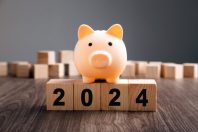 Piggy Bank on top of wooden block. Budget Plan 2024.