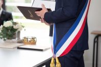 French mayor with a scarf flag during a weeding day