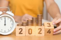 Happy New Year with vintage alarm clock and flipping 2023 change to 2024 block. Resolution, Goals, Plan, Action, Money Saving, Retirement fund, Pension, Investment and Financial concept