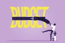 Tight budget and recession shrinking economy concept, Saving money, Businessman use belts tighten budget word, economy concept