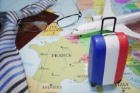 Vacation to France and tourism concept. Suitcase with french flag. 3D rendered illustration.
