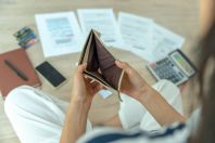 Women  managing debt and expenses. People holding wallet but no money to pay credit card.  broke, mortgage, loan, bankruptcy, bankrupt, can't to pay
