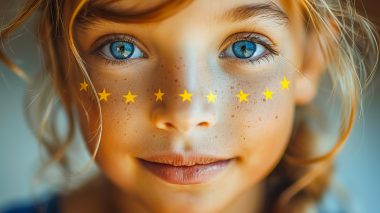Close-up of a child's face painted with eu stars, celebrating europe day