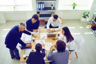 Business team analyzes sales charts and diagrams, develops a new strategy and discusses work issues.