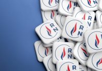 Elections in France. Logo of the far right party "Rassemblement National" on a heap on a table. Web banner format with copy space.