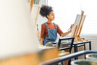 African kid drawing in classroom, young girl happy funny study a