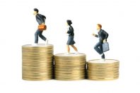 Miniature people toy figure photography. School admission budget concept. Pupils running above golden coin cent money staircase, isolated on white background