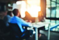 Meeting, boardroom and teamwork in office, blurred and lens flare in workplace. Planning, employee and conversation for colleagues and design for creative agency, group or business people