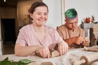 Girl laughing out loud while feeling happy during the master class of pottery
