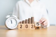2024 end year to Happy New Year 2025 with clock and coins stack arrangement. Money Saving for Future Plan, Retirement fund, Pension, Investment, Wealth Business, Financial and countdown concepts