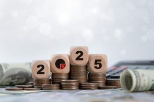 Tax 2025 wooden block on stack coin for income tax return.Tax, investment, financial, savings and New Year Resolution concepts. Business budget planning and investment growth in new year concept.